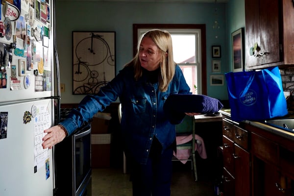 Barbara Teed unpacks a Meals on Wheels deliver for herself and her 30-year-old son Ryan, who has Down syndrome, on Wednesday, Jan. 29, 2025, in Bloomington, Minn. (AP photo/Mark Vancleave)