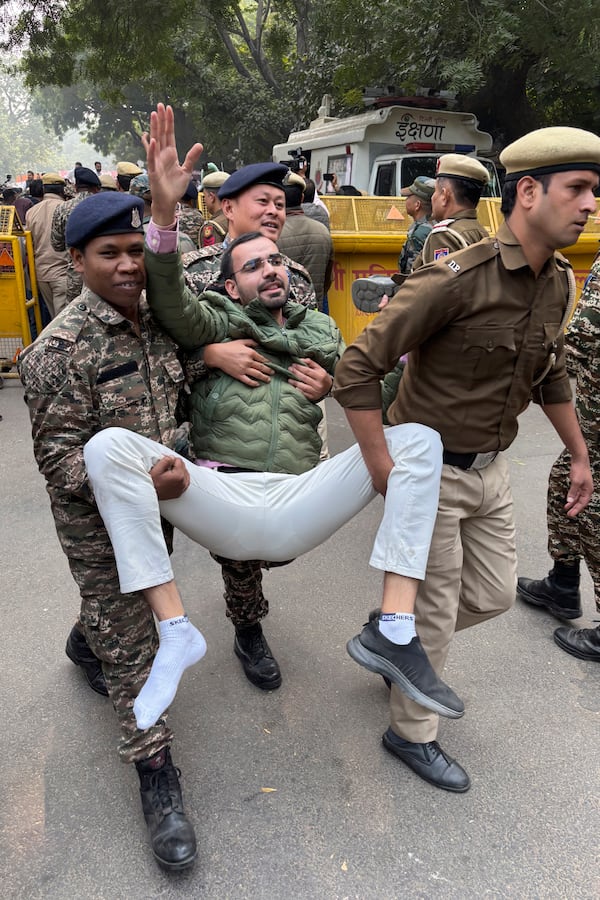 Police detain a Congress party supporter participating during a protest against Indian billionaire Gautam Adani and Indian Prime Minister Narendra Modi, after Adani was indicted by U.S. prosecutors for bribery and fraud, in New Delhi, India, Monday, Nov. 25, 2024. (AP Photo/Shonal Ganguly)