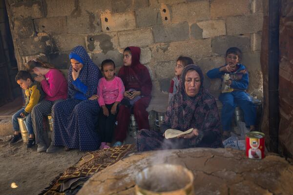 Amal Al-Jali, a 46-year-old mother of 14 displaced from Gaza City, prepares bread at a camp for displaced Palestinians in Deir al-Balah, Gaza Strip, on Nov. 7, 2024. (AP Photo/Abdel Kareem Hana)