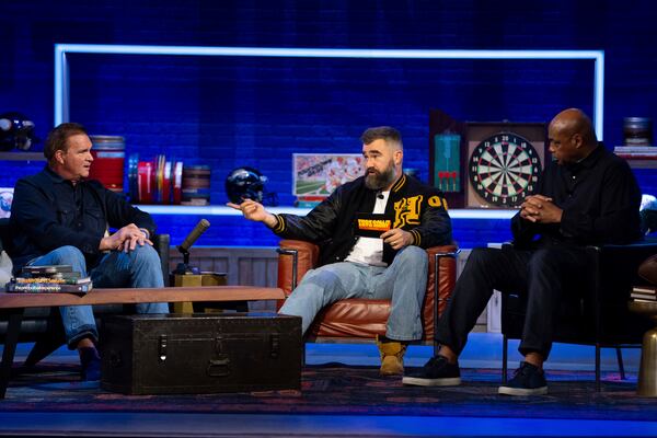 Former NFL player and ESPN analyst Jason Kelce, centert, talks with his guest, former NFL player Brian Baldinger, left and NBA Hall of Famer Charlies Barkley, right, during the taping of "They Call It Late Night with Jason Kelce", Friday, Jan. 3, 2025, in Philadelphia. (AP Photo/Chris Szagola)