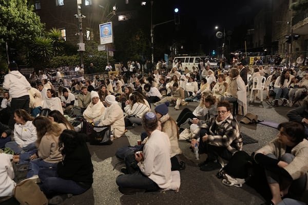 Relatives of hostages, held captive by Hamas in the Gaza Strip, and their supporters gather outside of Prime Minister Benjamin Netanyahu's residence in Jerusalem, Wednesday, Jan. 15, 2025. (AP Photo/Mahmoud Illean)