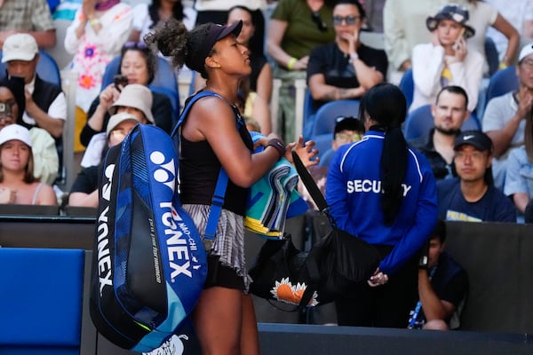 Naomi Osaka of Japan leaves the court after retiring from her third round match against Belinda Bencic of Switzerland at the Australian Open tennis championship in Melbourne, Australia, Friday, Jan. 17, 2025. (AP Photo/Manish Swarup)