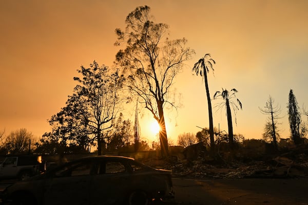 The sun sets over damage from the Eaton Fire, Thursday, Jan. 9, 2025, in Altadena, Calif. (AP Photo/Nic Coury)