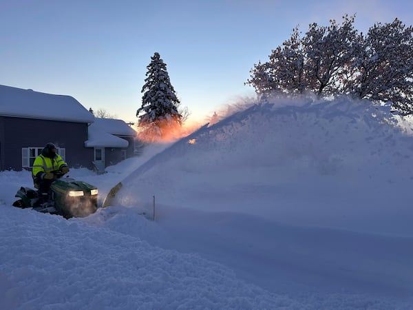 A snowplow clears snow as the sun rises in Lowville, N.Y., Monday, Dec. 2, 2024. (AP Photo/Cara Anna)