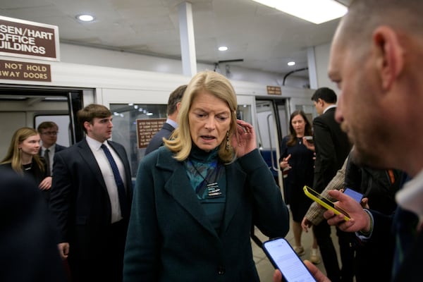 Sen. Lisa Murkowski, R-Alaska, talks with reporters as she makes her way through the Senate subway, Thursday, Jan. 23, 2025, in Washington. (AP Photo/Rod Lamkey, Jr.)