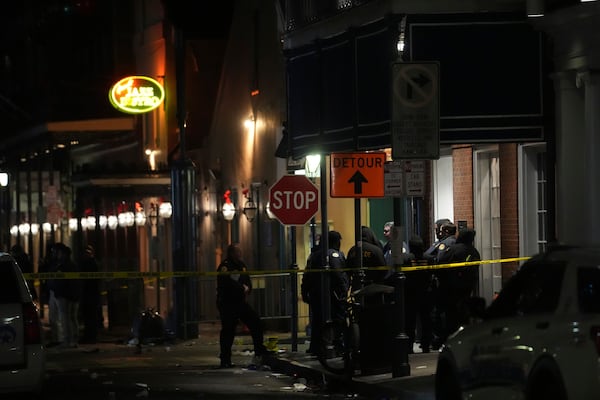 Emergency services attend the scene after a vehicle drove into a crowd on New Orleans' Canal and Bourbon Street, Wednesday Jan. 1, 2025. (AP Photo/Gerald Herbert)