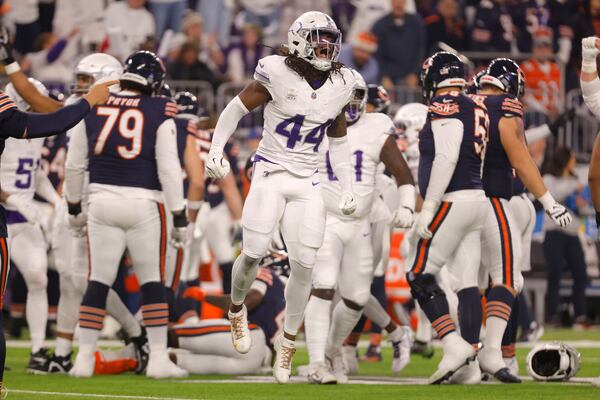 Minnesota Vikings safety Josh Metellus (44) celebrates a defensive stop during the first half of an NFL football game against the Chicago Bears, Monday, Dec. 16, 2024, in Minneapolis. (AP Photo/Bruce Kluckhohn)