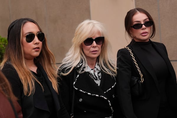 Tammi Menendez, center, the wife of Eric Menendez, leaves a courthouse after a hearing in Los Angeles, Monday, Nov. 25, 2024. (AP Photo/Jae C. Hong)