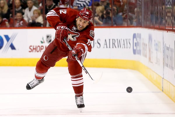 FILE - Phoenix Coyotes' Paul Bissonnette passes the puck against the Colorado Avalanche during the second period of an NHL hockey game Thursday, Nov. 21, 2013, in Glendale, Ariz. (AP Photo/Ross D. Franklin, File)