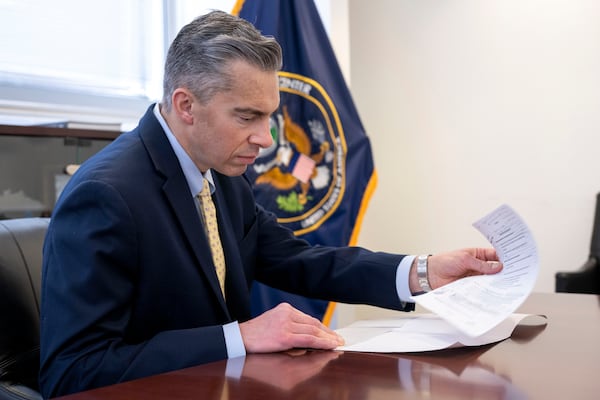 Acting Director of the National Counterterrorism Center Brett Holmgren looks over paperwork before the start of an interview at the National Counterterrorism Center, Jan. 8, 2025 in McLean, Va. (AP Photo/Kevin Wolf)