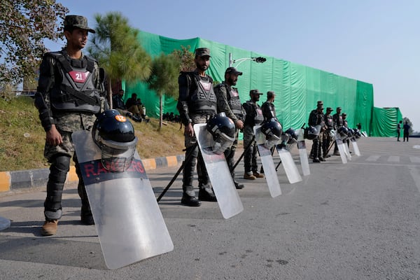 Paramilitary soldiers stand guard with riot gears at a road barricaded with shipping containers ahead of a planned rally by supporters of imprisoned former Prime Minister Imran Khan's Pakistan Tehreek-e-Insaf party, in Islamabad, Pakistan, Sunday, Nov. 24, 2024. (AP Photo/Anjum Naveed)