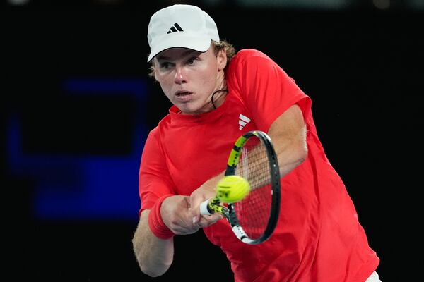 Alex Michelsen of the U.S. plays a backhand return during his fourth round match against Alex de Minaur of Australia at the Australian Open tennis championship in Melbourne, Australia, Monday, Jan. 20, 2025.(AP Photo/Manish Swarup)