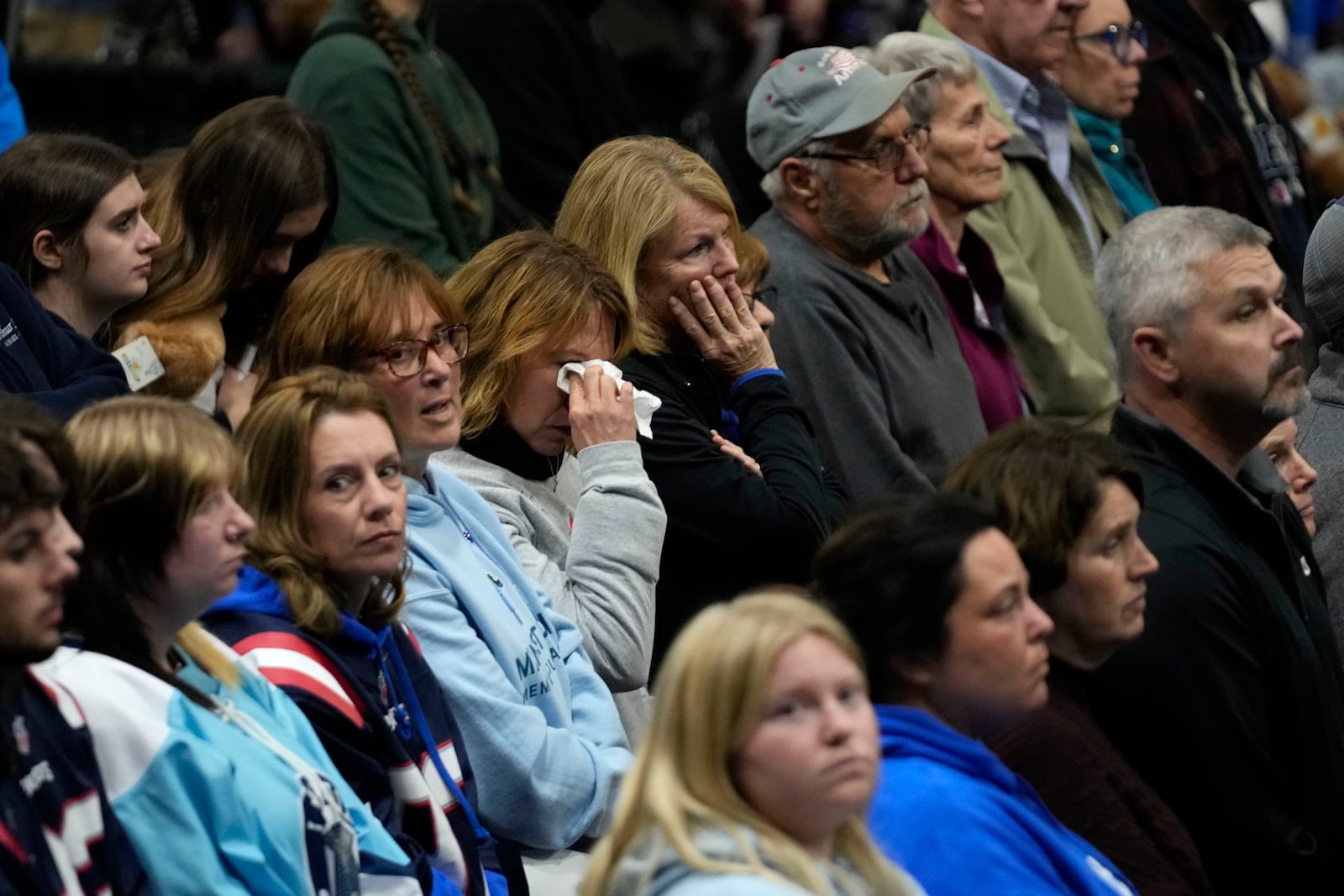 A woman wipes tears during the playing of Amazing Grace at a commemoration event to mark the one year anniversary of the mass shooting in Lewiston, Maine, Friday, Oct. 25, 2024. (AP Photo/Robert F. Bukaty)