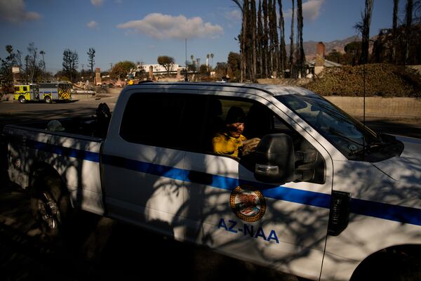 A member of the Navajo Scouts firefighter crew waits for an assignment at the Eaton Fire, Friday, Jan. 17, 2025, in Altadena, Calif. (AP Photo/John Locher)