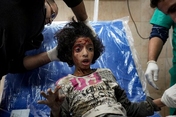 A Palestinian child wounded during the Israeli bombardment of the Gaza Strip receives treatment at the Al-Aqsa Hospital in Deir al-Balah, Thursday, Dec. 19, 2024. (AP Photo/Abdel Kareem Hana)