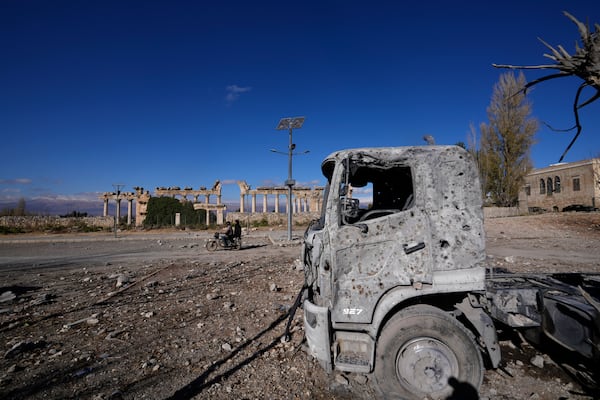 A damaged vehicle seen in front of part of the Roman temples of Baalbek in eastern Lebanon, Thursday, Nov. 28, 2024. (AP Photo/Hassan Ammar)