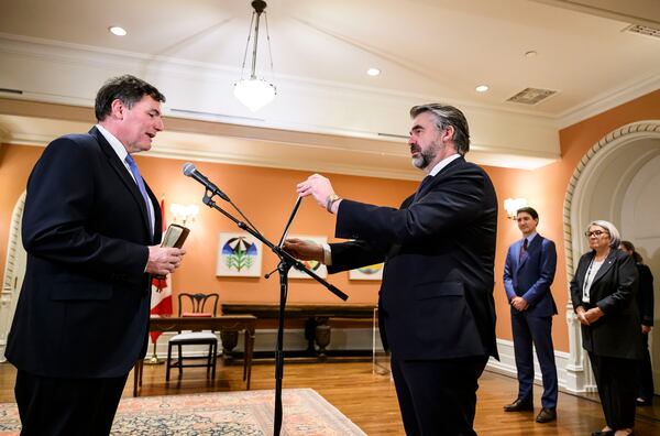 Dominic LeBlanc is sworn in as Minister of Finance by Clerk of the Privy Council John Hannaford, centre, as Canada's Prime Minister Justin Trudeau and Gov. Gen. Mary Simon look on, during a ceremony at Rideau Hall in Ottawa, Ontario, Monday, Dec. 16, 2024. (Justin Tang/The Canadian Press via AP)