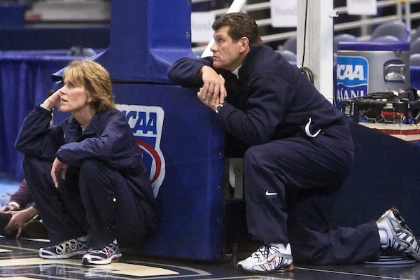 FILE - UConn coach Geno Auriemma, right, and associate head coach Chris Dailey, left, watch their team during a practice at the NCAA college basketball tournament in Hartford, Conn., Saturday, March 17, 2007.. (AP Photo/Bob Child, File)