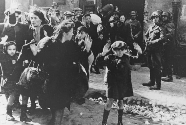 FILE - A group of Jews, including a small boy, is escorted from the Warsaw Ghetto by German soldiers on April 19, 1943. (AP Photo, File)