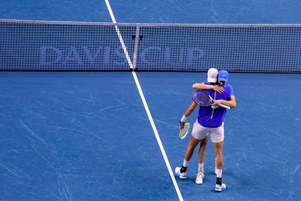 Italy's Jannik Sinner and Matteo Berrettini celebrate their victory against Argentina's Maximo Gonzalez and Andres Molteni during their doubles tennis quarterfinal Davis Cup match at the Martin Carpena Sports Hall in Malaga, southern Spain, on Thursday, Nov. 21, 2024. (AP Photo/Manu Fernandez)