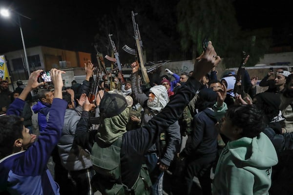 Syrian rebel fighters shout slogans against the late Assad regime in the Mazzeh district in Damascus Wednesday Dec. 25, 2024 (AP Photo/Omar Sanadiki)