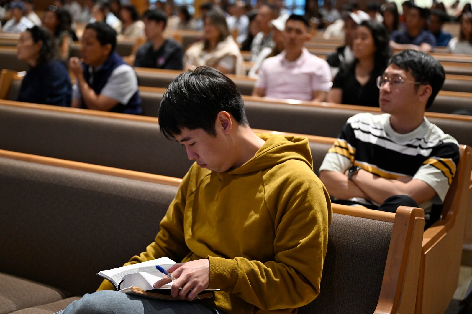 Samuel Lee reads his bible during a service at the Christ Central Presbyterian Church, Sunday, Oct. 13, 2024 in Centreville. (AP Photo/John McDonnell)