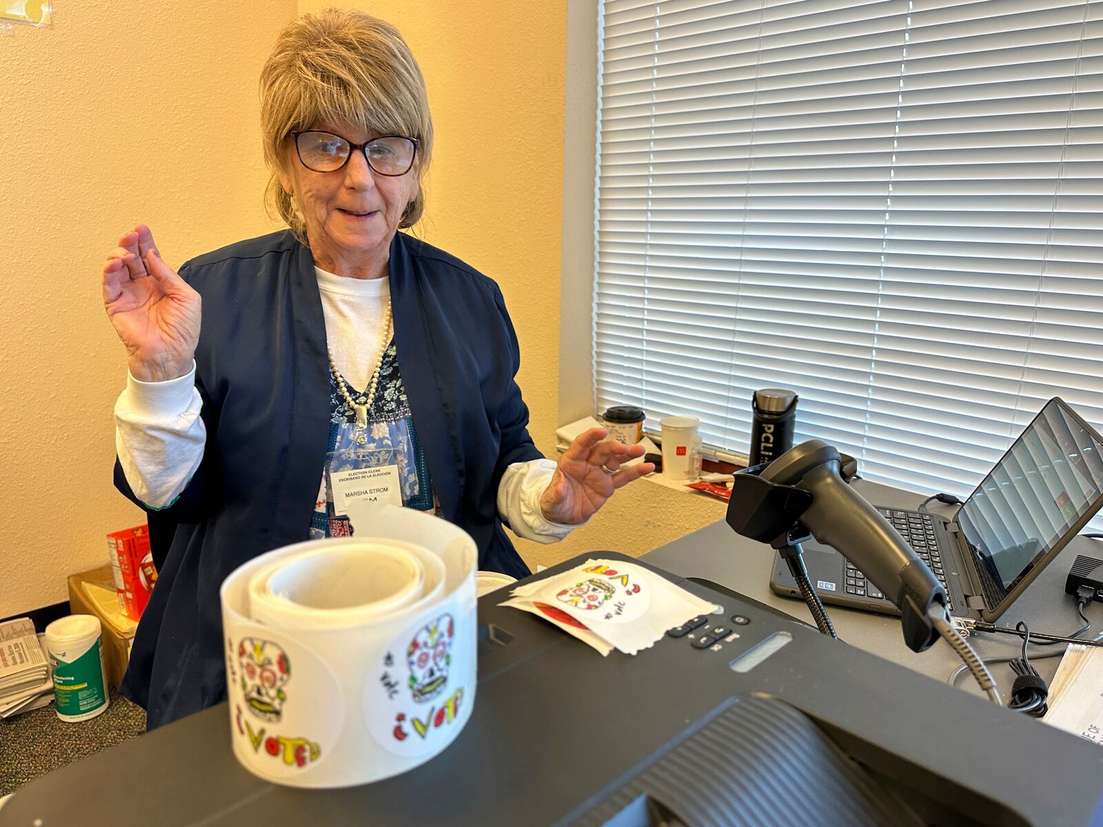 Election worker Marsha Strom prepares to hand out I Voted stickers at an early voting center in Albuquerque, N.M., on Wednesday, Oct. 30, 2024. (AP Photo/Susan Montoya Bryan)