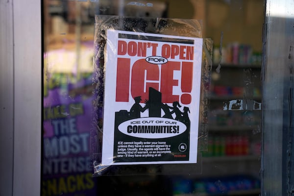 A sign regarding the U.S. Immigration and Customs Enforcement is posted on the window of a corner store on the day of President Trump's Inauguration, Monday, Jan. 20, 2025, in the predominantly Latino Little Village neighborhood Chicago. (AP Photo/Erin Hooley)