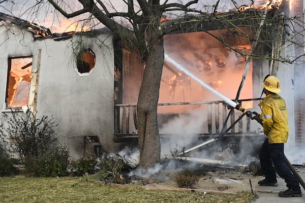 A firefighter battles the Eaton Fire, Wednesday, Jan. 8, 2025, in Altadena, Calif. (AP Photo/Nic Coury)