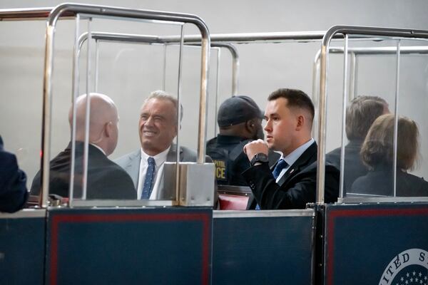 Robert Kennedy Jr., second from right, President-elect Donald Trump's pick to lead the Health and Human Services Department, rides the Capitol subway as he travels between meetings with senators on Capitol Hill, Tuesday, Dec. 17, 2024, in Washington. (AP Photo/Mark Schiefelbein)