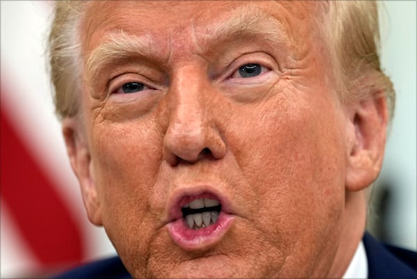 President Donald Trump speaks to reporters as he signs executive orders in the Oval Office of the White House, Thursday, Jan. 23, 2025, in Washington. (AP Photo/Ben Curtis)