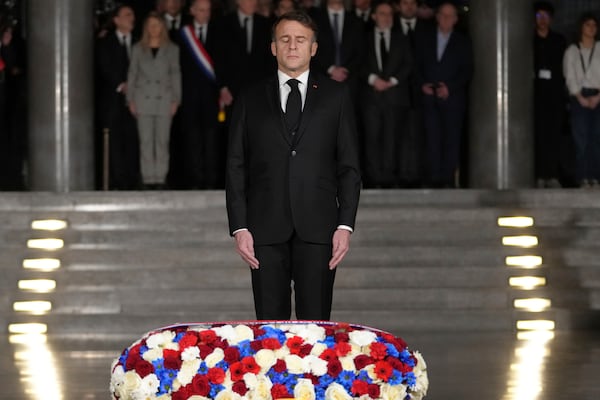 French President Emmanuel Macron closes his eyes after laying a wreath at the Paris Holocaust Memorial and before heading to Auschwitz for the international ceremony marking 80 years since the liberation of the Nazi death camp and Holocaust Remembrance Day, Monday, Jan. 27, 2025 in Paris. (AP Photo/Thibault Camus, Pool)