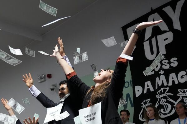 Activists participate in a demonstration for climate finance at the COP29 U.N. Climate Summit, Thursday, Nov. 21, 2024, in Baku, Azerbaijan. (AP Photo/Sergei Grits)