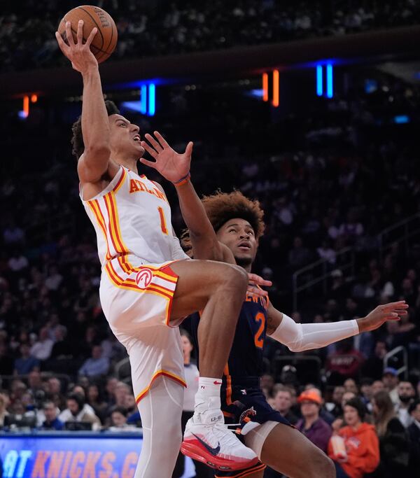 Atlanta Hawks' Jalen Johnson (1) drives past New York Knicks' Miles McBride (2) during the first half of an Emirates NBA Cup basketball game Wednesday, Dec. 11, 2024, in New York. (AP Photo/Frank Franklin II)