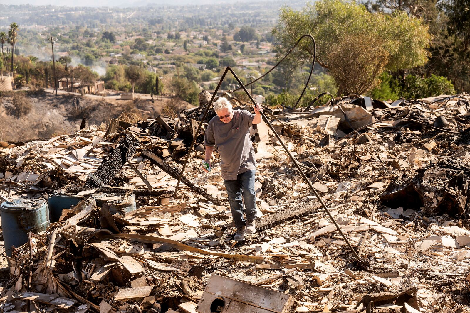 Joey Parish walks through his home, Friday, Nov. 8, 2024, which was destroyed by the Mountain Fire in Camarillo, Calif. (AP Photo/Noah Berger)