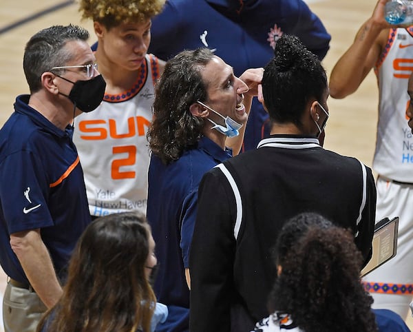 FILE - Connecticut Sun assistant coach Chris Koclanes, center, talks with players during a timeout at a WNBA basketball game against the Washington Mystics, May 28, 2021, in Uncasville, Conn. (Sean D. Elliot/The Day via AP, File) )