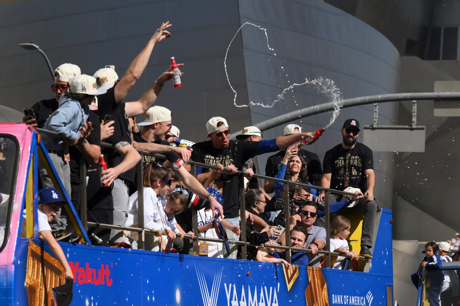 Los Angeles Dodgers players celebrate with fans during the baseball team's World Series championship parade Friday, Nov. 1, 2024, in Los Angeles. (AP Photo/Kyusung Gong)