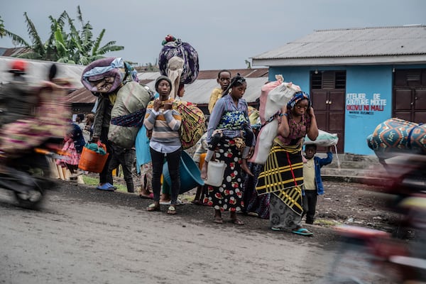 People displaced by the fighting with M23 rebels make their way to the center of Goma, Democratic Republic of the Congo, Sunday, Jan. 26, 2025. (AP Photo/Moses Sawasawa)