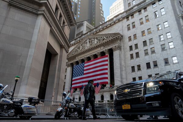 An NYPD officer walks outside of the New York Stock Exchange, Thursday, Dec. 12, 2024, in New York. (AP Photo/Julia Demaree Nikhinson)