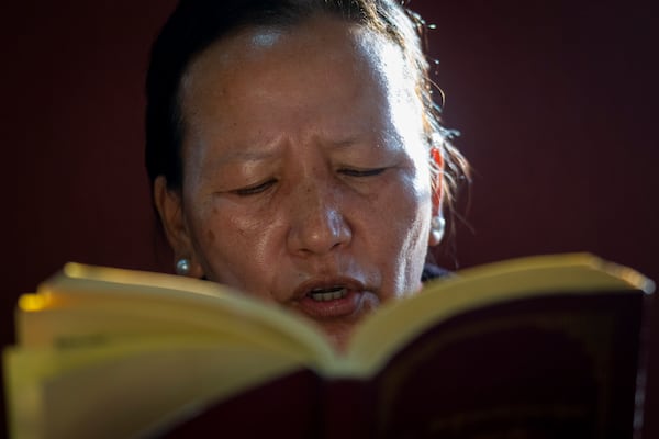 A Tibetan woman offers a prayer in the remembrance of those who lost their lives in the recent earthquake, at a Tibetan camp in Lalitpur, Nepal, on Wednesday, Jan. 8, 2025. (AP Photo/Niranjan Shrestha)