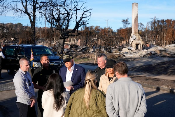 President Donald Trump and first lady Melania Trump talks with residents affected by the wildfires as they tour the Pacific Palisades neighborhood of Los Angeles, Friday, Jan. 24, 2025. (AP Photo/Mark Schiefelbein)