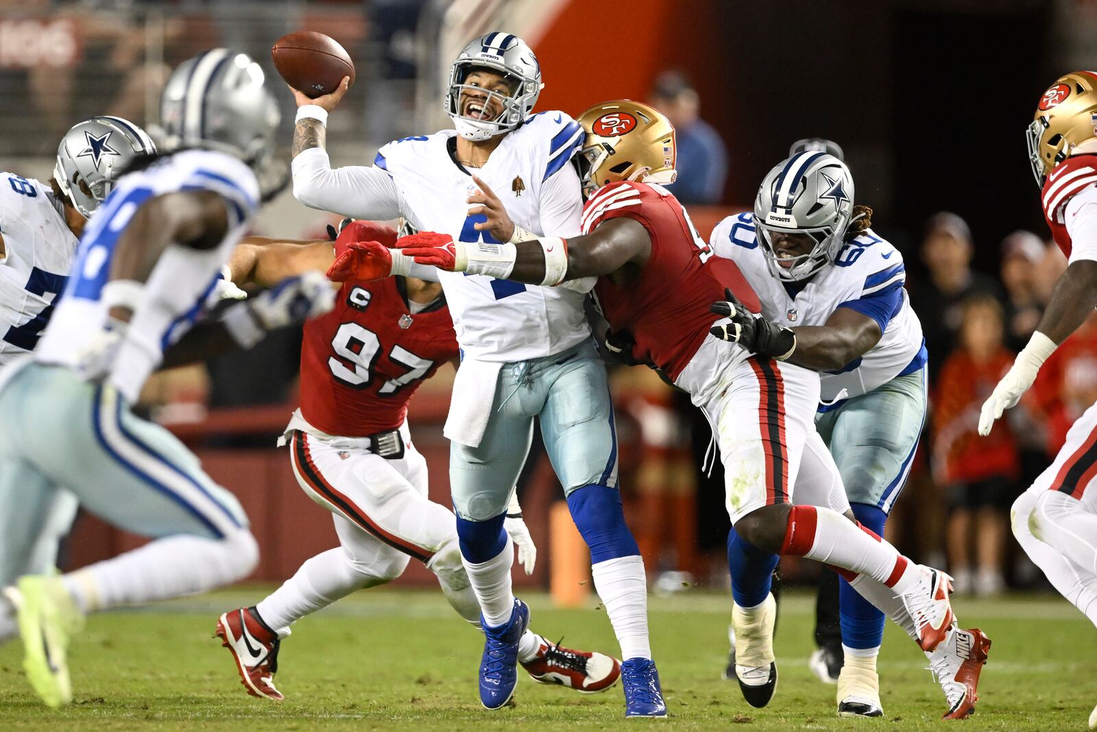 Dallas Cowboys quarterback Dak Prescott, middle, is hit by San Francisco 49ers defensive tackle Sam Okuayinonu during the first half of an NFL football game in Santa Clara, Calif., Sunday, Oct. 27, 2024. (AP Photo/Eakin Howard)