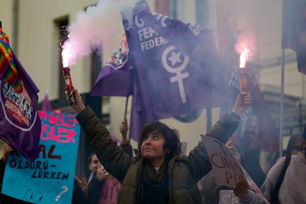 A woman holds a torch during a rally marking the upcoming International Day for the Elimination of Violence Against Women, in Istanbul,Turkey, Sunday, Nov. 24, 2024. (AP Photo/Emrah Gurel)