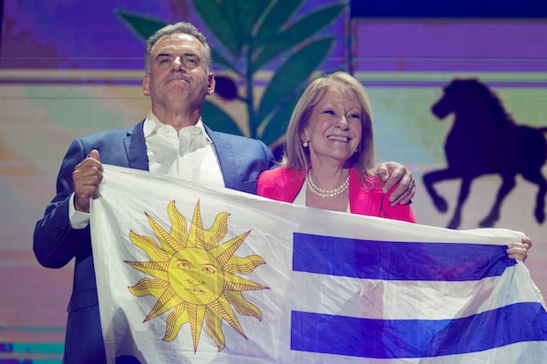 Yamandu Orsi, candidate for the Broad Front (Frente Amplio) and running mate Carolina Cosse celebrate after polls closed in the presidential run-off election in Montevideo, Uruguay, Sunday, Nov. 24, 2024. (AP Photo/Natacha Pisarenko)