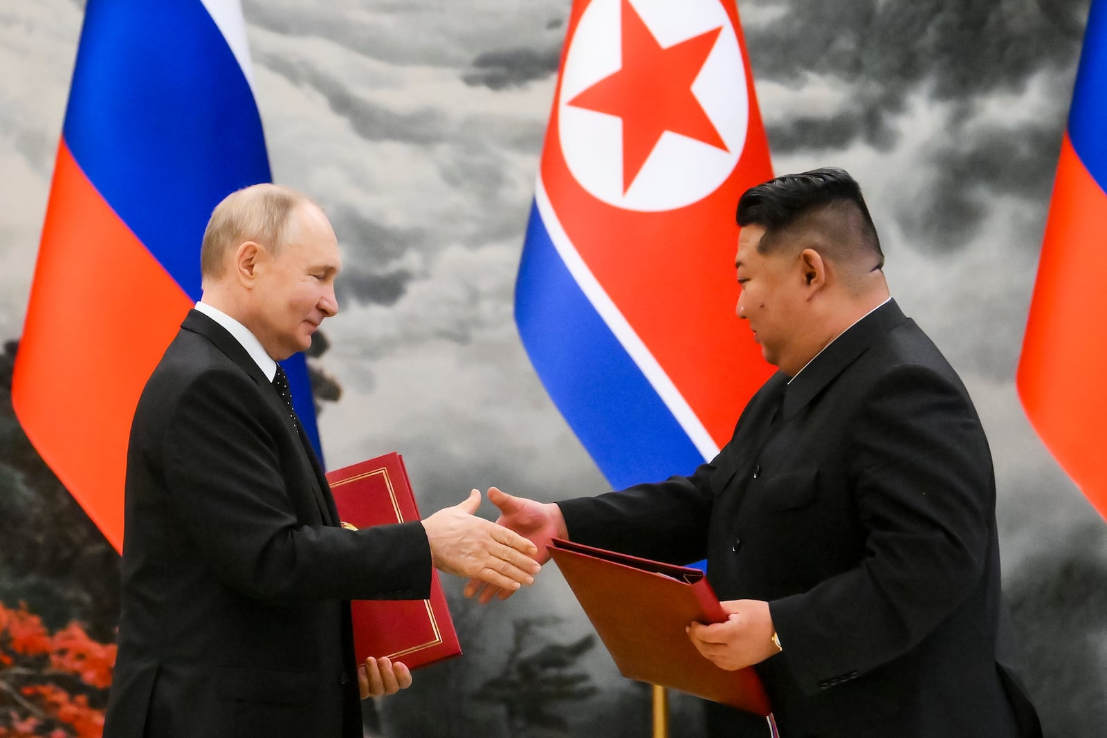 FILE - Russian President Vladimir Putin, left, and North Korea's leader Kim Jong Un exchange documents during a signing ceremony of the new partnership in Pyongyang, North Korea, on June 19, 2024. (Kristina Kormilitsyna, Sputnik, Kremlin Pool Photo via AP, File)