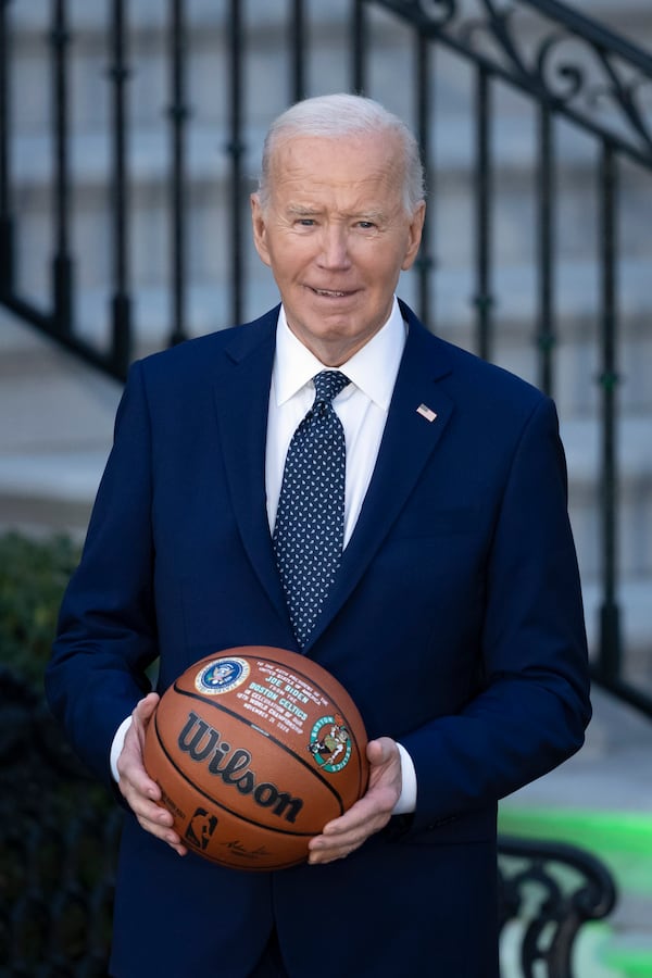 President Joe Biden holds a basketball he received from the Boston Celtics at an event to celebrate their victory in the 2024 National Basketball Association Championship, on the South Lawn of the White House in Washington, Thursday, Nov. 21, 2024. (AP Photo/Ben Curtis)