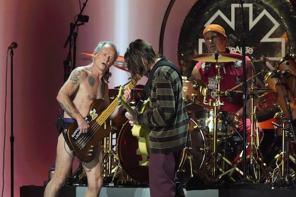 Flea, from left, John Frusciante, and Chad Smith of Red Hot Chili Peppers perform during the FireAid benefit concert on Thursday, Jan. 30, 2025, at The Forum in Inglewood, Calif. (AP Photo/Chris Pizzello)