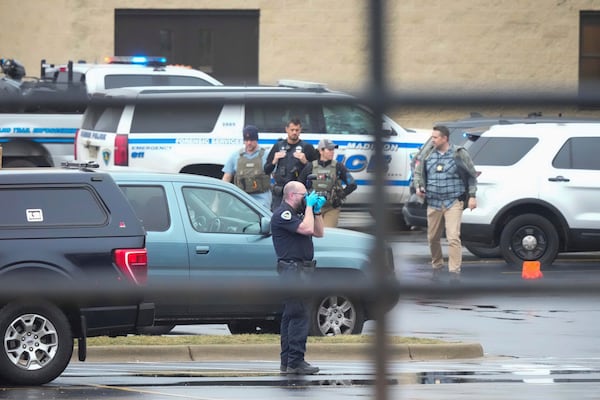 Police investigate as emergency vehicles are parked outside the Abundant Life Christian School in Madison, Wis., where multiple injuries were reported following a shooting, Monday, Dec. 16, 2024. (AP Photo/Morry Gash)