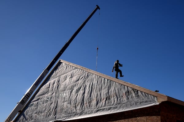 FILE - Construction workers frame a new single-family home on Dec. 6, 2024, in Owensboro, Ky. (AP Photo/Charlie Riedel)