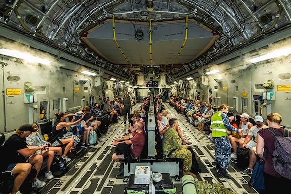 This photo released by Australian Department of Defence, shows Australian citizens on board a Royal Australian Air Force aircraft for a flight home from Bauerfield International Airport, Port Vila, Vanuatu, Wednesday, Dec. 18, 2024 following a powerful earthquake that struck just off the coast of Vanuatu in the South Pacific Ocean. (CPL Adam Abela/Australian Department of Defence via AP)